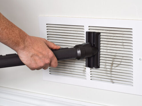 rsz 1person s hand vacuuming dirty return air vents 2023 11 27 04 51 47 utc